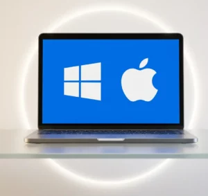 Ordinateur portable affichant les logos Windows et Apple pour le support IT à Genève.